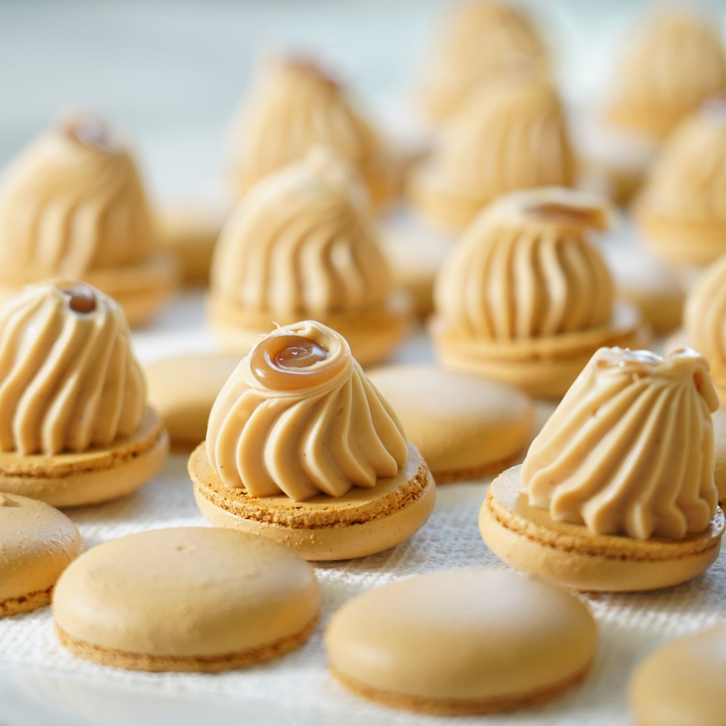 Close-up of decorative macarons with caramel filling on a white background